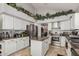 Bright kitchen featuring stainless steel appliances, tile floors, granite countertops, and island at 5622 E Gelding Dr, Scottsdale, AZ 85254