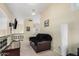 Second-story living room featuring a cozy couch, a television, and wrought iron banister at 5622 E Gelding Dr, Scottsdale, AZ 85254