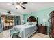 Bright main bedroom with patio access, an elegant ceiling fan, and cool green tones at 5622 E Gelding Dr, Scottsdale, AZ 85254