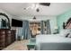 Light-filled main bedroom with patio access, a ceiling fan, and cool tones at 5622 E Gelding Dr, Scottsdale, AZ 85254