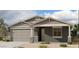 Charming single-story home with a two-car garage, covered porch, and well-maintained landscaping at 5631 W Summerside Rd, Laveen, AZ 85339