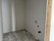 Unfinished laundry room with visible drywall and visible hookups for the future washer and dryer at 5631 W Summerside Rd, Laveen, AZ 85339