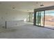 Spacious unfinished living room with visible drywall, a large sliding glass door leading to the outdoors at 5631 W Summerside Rd, Laveen, AZ 85339