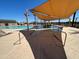 Resort-style community pool with wading area, shade canopies, and comfortable lounging at 5631 W Summerside Rd, Laveen, AZ 85339