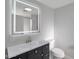 Modern bathroom with illuminated mirror, vanity, and toilet at 6125 E Indian School Rd # 131, Scottsdale, AZ 85251