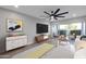 This staged bedroom boasts a ceiling fan, patio access, modern décor, and neutral color palette at 6125 E Indian School Rd # 131, Scottsdale, AZ 85251