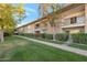 Well-maintained apartment building exterior with mature trees and manicured green lawn at 6125 E Indian School Rd # 131, Scottsdale, AZ 85251