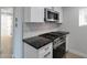 Updated kitchen features stainless steel appliances and modern finishes at 6125 E Indian School Rd # 131, Scottsdale, AZ 85251
