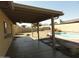 Covered back patio with views of the pool and landscaped yard at 6242 E Hearn Rd, Scottsdale, AZ 85254