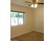 Bright bedroom featuring a window and neutral carpet flooring at 6242 E Hearn Rd, Scottsdale, AZ 85254