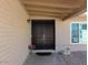 Elegant double front doors under a covered porch, complemented by desert landscaping and a side window at 6242 E Hearn Rd, Scottsdale, AZ 85254