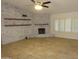 Living room features a painted brick wall and fireplace at 6242 E Hearn Rd, Scottsdale, AZ 85254