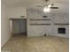 Living room boasts a painted brick fireplace and ceiling fan at 6242 E Hearn Rd, Scottsdale, AZ 85254