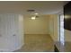 Open-concept living room with tile flooring, ceiling fan, and access to a patio at 6242 E Hearn Rd, Scottsdale, AZ 85254