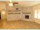 Bright living room with a vaulted ceiling, brick fireplace, and neutral tile floors, perfect for gatherings at 6242 E Hearn Rd, Scottsdale, AZ 85254
