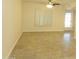 Living room featuring tile flooring, shuttered window, and ceiling fan at 6242 E Hearn Rd, Scottsdale, AZ 85254