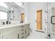Stylish bathroom with dual sinks, modern fixtures, and a glass-enclosed shower at 6439 W Adobe Dr, Glendale, AZ 85308