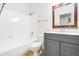 Well-lit bathroom features a shower-tub combo, modern vanity, and updated fixtures at 6439 W Adobe Dr, Glendale, AZ 85308