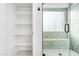 Bathroom featuring a glass-enclosed shower with built-in shelving and a tiled bench at 6439 W Adobe Dr, Glendale, AZ 85308