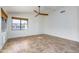 Bedroom features wood tile flooring, neutral paint, ceiling fan, and a large window with natural light at 6439 W Adobe Dr, Glendale, AZ 85308