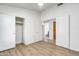Bright bedroom with wood floors and ample closet space with access to a private bathroom at 6439 W Adobe Dr, Glendale, AZ 85308