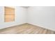 Bedroom featuring wood-look flooring and a window with blinds, providing natural light at 6439 W Adobe Dr, Glendale, AZ 85308