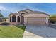 Charming single-Gathering home featuring a two-car garage, low maintenance landscaping, and a desert-style front yard at 6439 W Adobe Dr, Glendale, AZ 85308