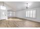 Bright, airy living room featuring vaulted ceilings, wood floors, modern lighting, and plantation shutters at 6439 W Adobe Dr, Glendale, AZ 85308
