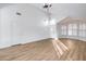 Spacious living room features vaulted ceilings, wood floors, modern lighting, and ample natural light at 6439 W Adobe Dr, Glendale, AZ 85308