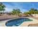 Sparkling kidney-shaped pool with a diving board and desert landscaping at 6439 W Adobe Dr, Glendale, AZ 85308