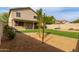 The backyard has artificial grass, desert landscaping, a patio with furniture, and a swing set for endless outdoor fun at 6785 W Tether Trl, Peoria, AZ 85383