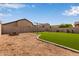 Spacious backyard with artificial turf, a swing set, fire pit, and desert landscaping at 6785 W Tether Trl, Peoria, AZ 85383