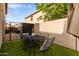 Cozy backyard with artificial turf, dining furniture, and a decorative planter at 6785 W Tether Trl, Peoria, AZ 85383
