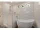 Modern bathroom features a soaking tub and separate shower, perfect for unwinding after a long day at 6785 W Tether Trl, Peoria, AZ 85383