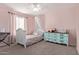 Cozy bedroom featuring a white bed frame, soft pink walls, and a whimsical decorative canopy at 6785 W Tether Trl, Peoria, AZ 85383