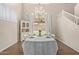 Dining room with a chandelier, a white table set for dinner and backyard access at 6785 W Tether Trl, Peoria, AZ 85383