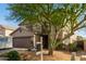Attractive two-story home featuring a well-kept front yard with desert landscaping, a two-car garage, and a seating area at 6785 W Tether Trl, Peoria, AZ 85383