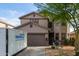 Inviting two-story home with a well-maintained front yard, a charming entrance, and a two-car garage at 6785 W Tether Trl, Peoria, AZ 85383