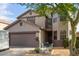 Attractive two-story home featuring a well-kept front yard with desert landscaping, a two-car garage, and a seating area at 6785 W Tether Trl, Peoria, AZ 85383
