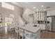Open-concept kitchen with white cabinets, stainless appliances, large island and adjacent dining area at 6785 W Tether Trl, Peoria, AZ 85383