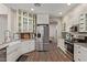 Bright kitchen featuring white cabinets, stainless steel appliances, and modern fixtures at 6785 W Tether Trl, Peoria, AZ 85383