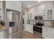 Contemporary kitchen with stainless steel appliances, white cabinets, and a sleek design at 6785 W Tether Trl, Peoria, AZ 85383