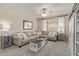 Comfortable living room with a plush sectional sofa, a ceiling fan, and soft, neutral decor at 6785 W Tether Trl, Peoria, AZ 85383