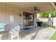 Outdoor patio with comfortable seating, ceiling fan, and outdoor kitchen area at 6785 W Tether Trl, Peoria, AZ 85383