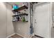 Storage area with wooden shelves stocked with cleaning supplies and household items at 6785 W Tether Trl, Peoria, AZ 85383