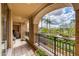 Charming balcony features decorative iron railings and a view of lush landscaping and palm trees at 7181 E Camelback Rd # 208, Scottsdale, AZ 85251