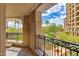 This relaxing balcony has decorative iron railings and a view of landscaped common space at 7181 E Camelback Rd # 208, Scottsdale, AZ 85251