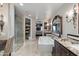 Elegant bathroom with a freestanding tub, walk-in shower, vanity, and direct bedroom access at 7181 E Camelback Rd # 208, Scottsdale, AZ 85251