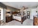 Spacious bedroom featuring a large bed, hardwood furniture, carpet flooring, and natural lighting at 7181 E Camelback Rd # 208, Scottsdale, AZ 85251