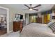 Spacious bedroom featuring a large bed, hardwood furniture, balcony access, and natural lighting at 7181 E Camelback Rd # 208, Scottsdale, AZ 85251